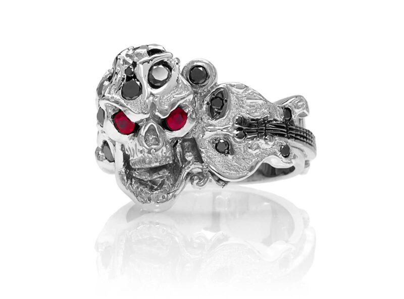 RG1008-B The Rock Star Skull Ring (Front View) in White Gold with Black Diamonds, White Diamonds and Rubies, designed by Steve Soffa