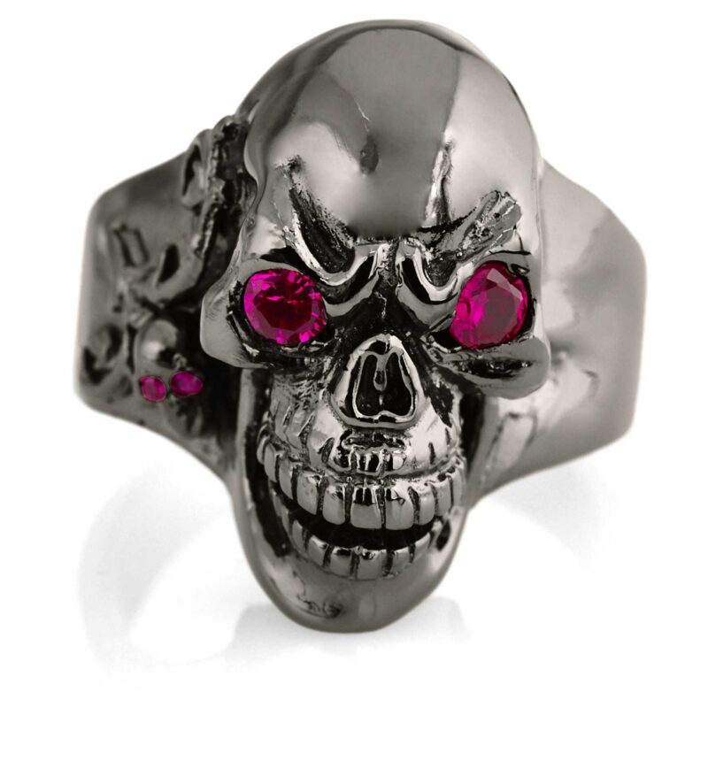 RG102-BK-RD The Player skull ring is cast in 20 grams 999 rhodium plated Sterling Silver with red stones. From the Black Collection, designed by Steve Soffa