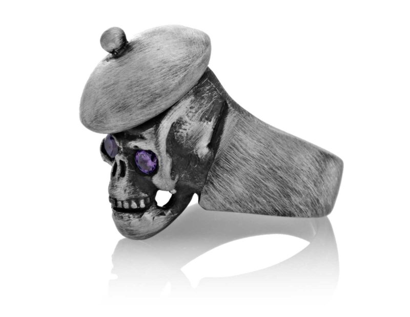 RG104-A The Artist Skull Ring (Left Side View) in Sterling Silver with Plum Stones, designed by Steve Soffa