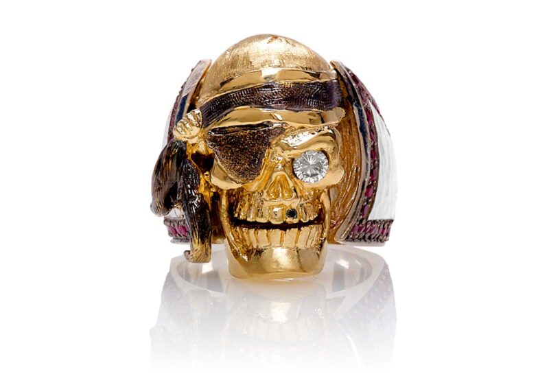 RG1040YGSIL Ol' Jack Danny Skull Ring (Front View) in Yellow/Rose Gold and Silver, with Rubies and Black/White Diamonds, designed by Steve Soffa