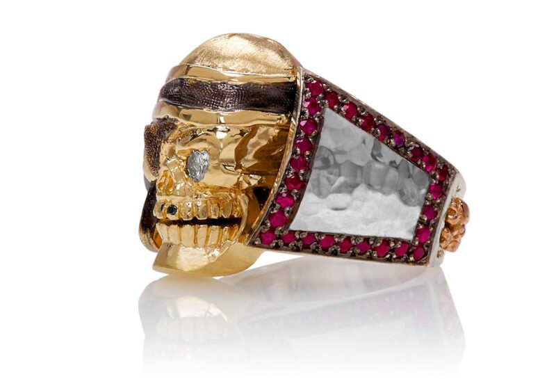 RG1040YGSIL Ol' Jack Danny Skull Ring (Left Side View) in Yellow/Rose Gold and Silver, with Rubies and Black/White Diamonds, designed by Steve Soffa