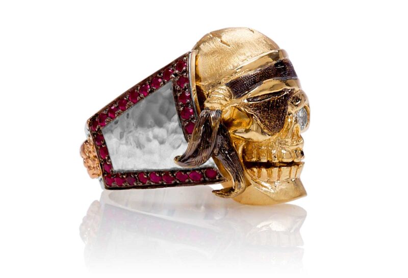 RG1040YGSIL Ol' Jack Danny Skull Ring (Right Side View) in Yellow/Rose Gold and Silver, with Rubies and Black/White Diamonds, designed by Steve Soffa