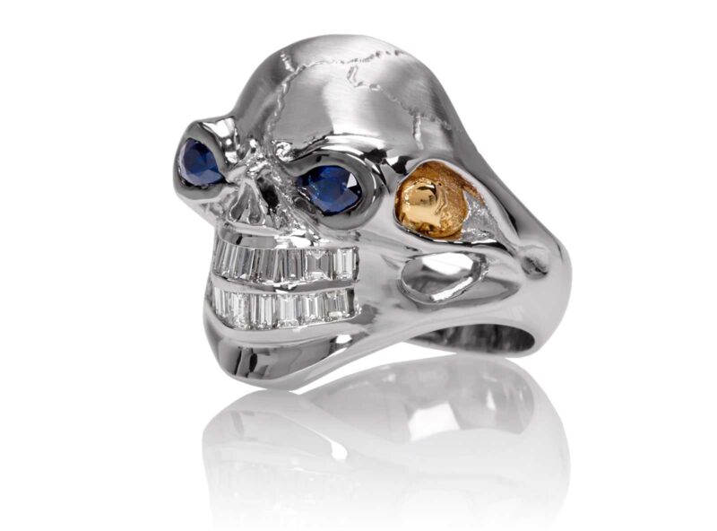 RG3020WH-B Monstrous Max Skull Ring (Front Side View) in White Gold Blue Sapphire eyes, designed by Steve Soffa