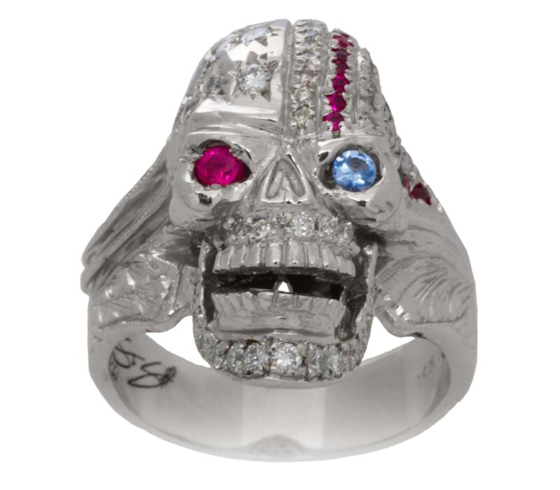 RG1006 The Freedom Rider Skull Ring (Front View) in White Gold with White Diamonds, Red Rubies and Blue Sapphire (Diamond Collection), designed by Steve Soffa