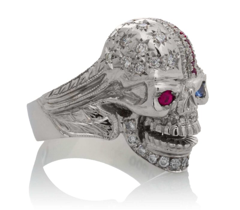 RG1006 The Freedom Rider Skull Ring (Right Side) in White Gold with White Diamonds, Red Rubies and Blue Sapphire (Diamond Collection), designed by Steve Soffa