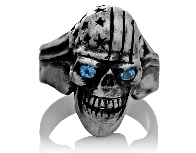 RG106-A The Freedom Rider Jewelry Skull Ring (Front View) in Silver with Blue Stones, designed by Steve Soffa