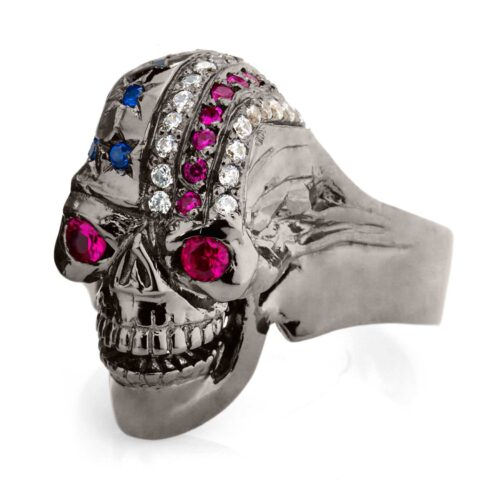 RG106BK-RD The Freedom Rider jewelry Skull Ring (Left Side View) in Rhodium Plated Sterling Silver in Blue Stones, with Blue, White & Red (Black Collection), designed by Steve Soffa