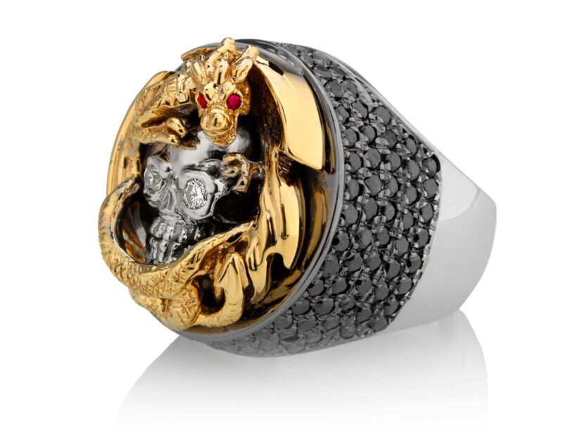 RG2508YG-WHT-BK-RD Dragon Of Deception Skull Ring (Left Side View) in Yellow Gold with White & Black Diamonds & Red Stones, designed by Steve Soffa