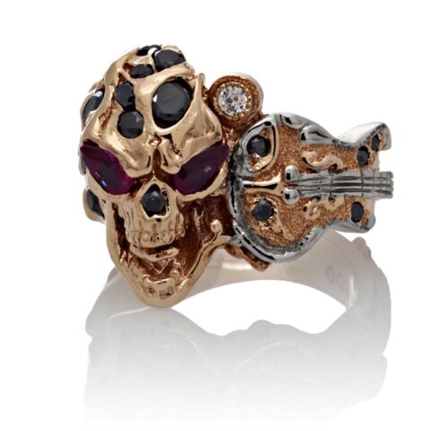 RG1008-A The Rock Star Skull Ring (Front View) in Rose/White Gold, with Black/White Diamonds and Rubies, designed by Steve Soffa