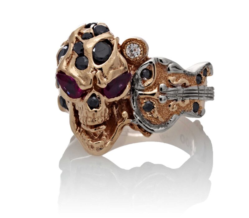 RG1008-A The Rock Star Skull Ring (Front View) in Rose/White Gold, with Black/White Diamonds and Rubies, designed by Steve Soffa