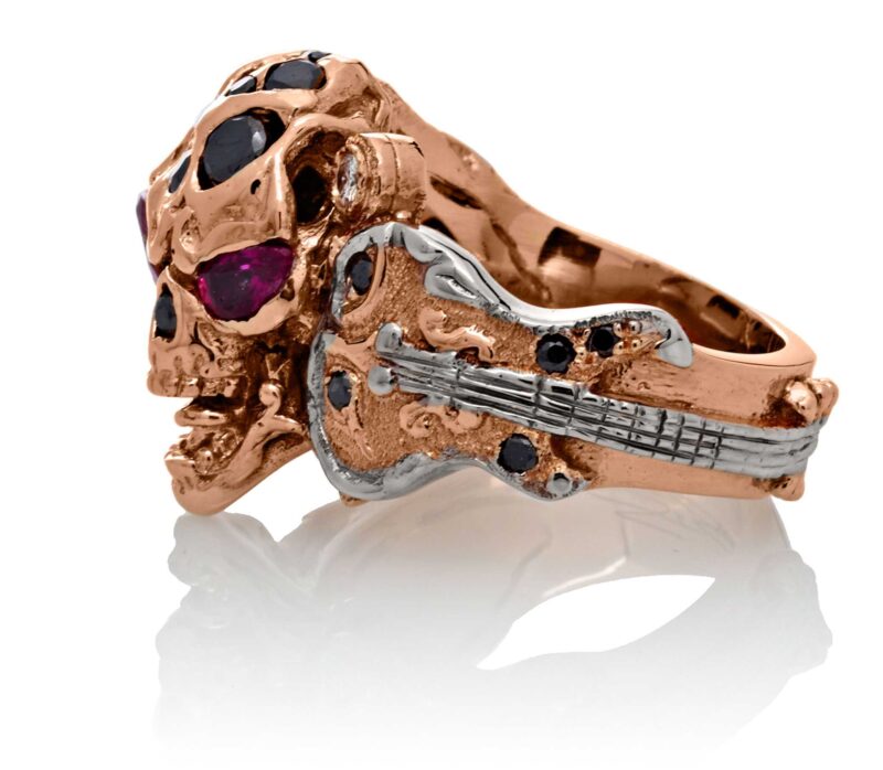 RG1008-A The Rock Star Skull Ring (Left Side View) in Rose/White Gold, with Black/White Diamonds and Rubies, designed by Steve Soffa