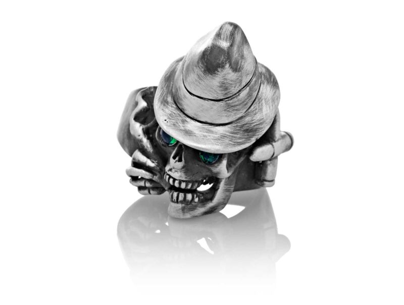 RG100-B The Gangster Skull Ring (Front View) in Sterling Silver with Green Stones, designed by Steve Soffa