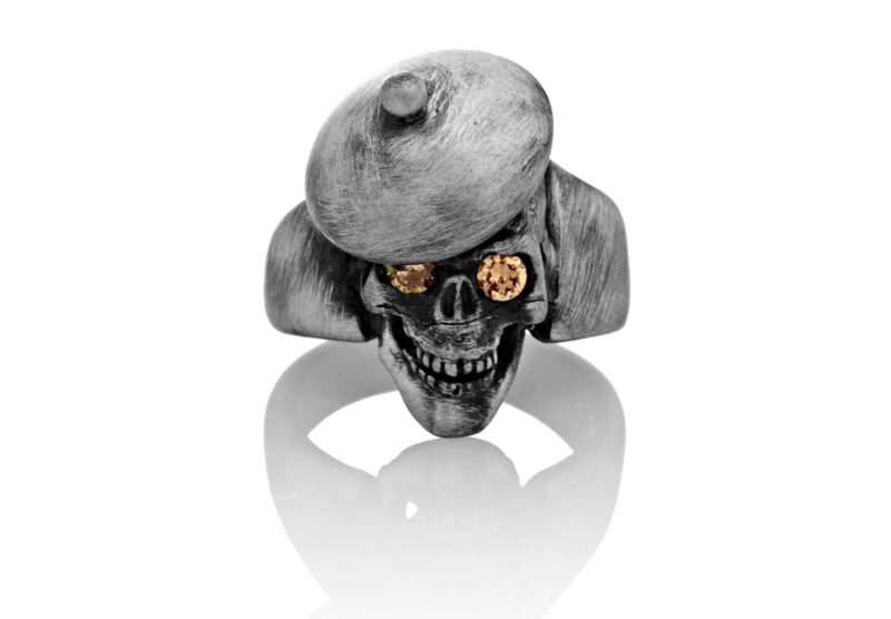 RG104-B The Artist Skull Ring (Front View) in Sterling Silver with Amber Stones, designed by Steve Soffa