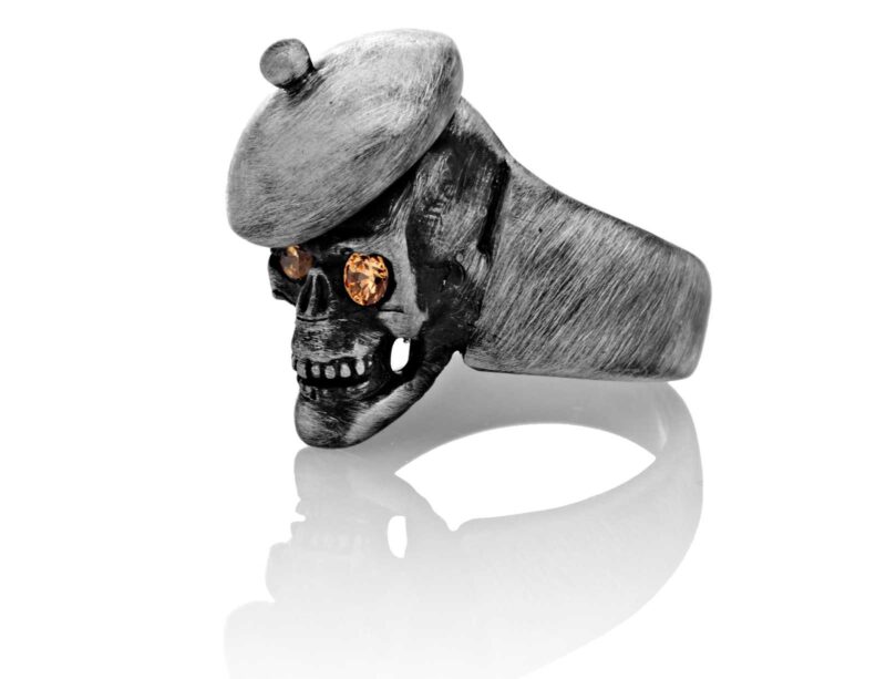 RG104-B The Artist Skull Ring (Left Front Side View) in Sterling Silver with Amber Stones, designed by Steve Soffa