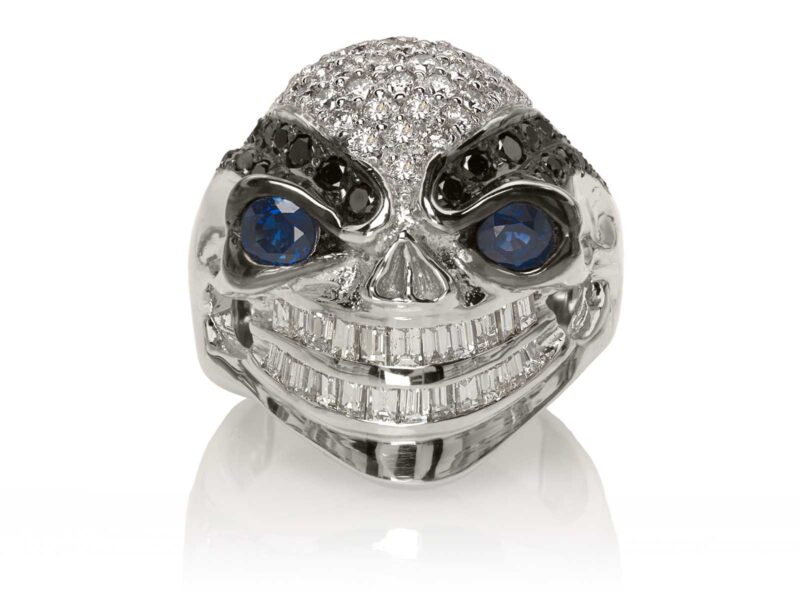 RG3028 Wicked Willy skull ring (Front View) in White Gold with White & Black Diamonds, Blue Sapphires, designed by Steve Soffa