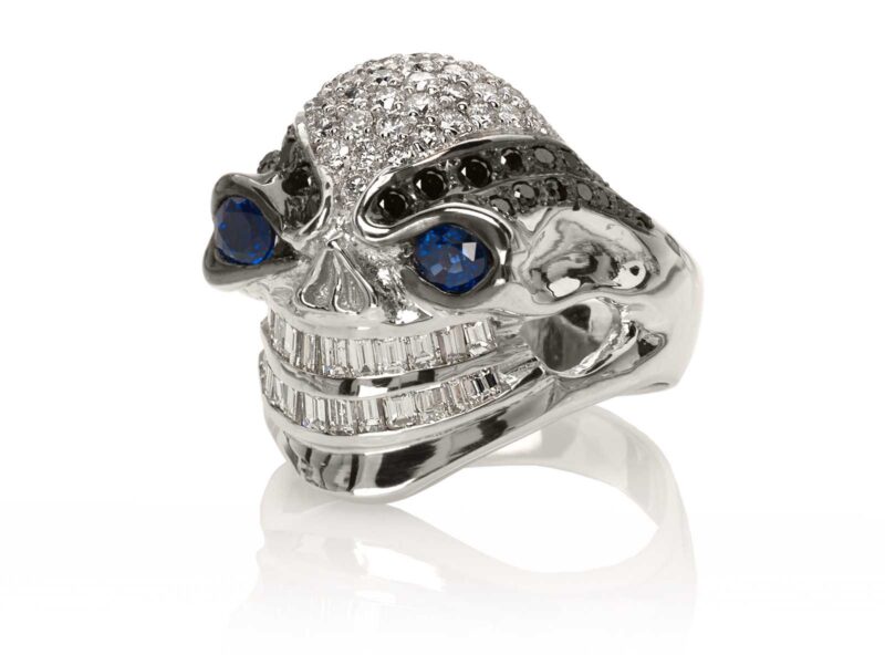 RG3028 Wicked Willy skull ring (Front Side View) in White Gold with White & Black Diamonds, Blue Sapphires, designed by Steve Soffa