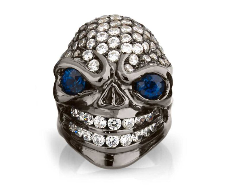 RG326BK-BL-WHT Sarcastic Sally Skull Ring (Front View) in Sterling Silver with Blue & White Stones (Black Collection), designed by Steve Soffa