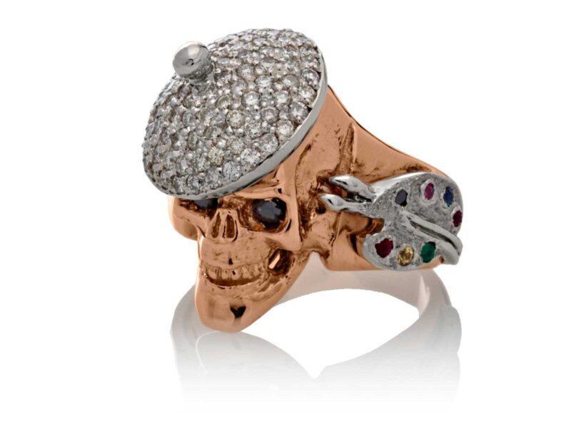 RG1004-A The Artist Skull Ring (Left Front View) in Rose and White Gold, with White and Black Diamonds, designed by Steve Soffa