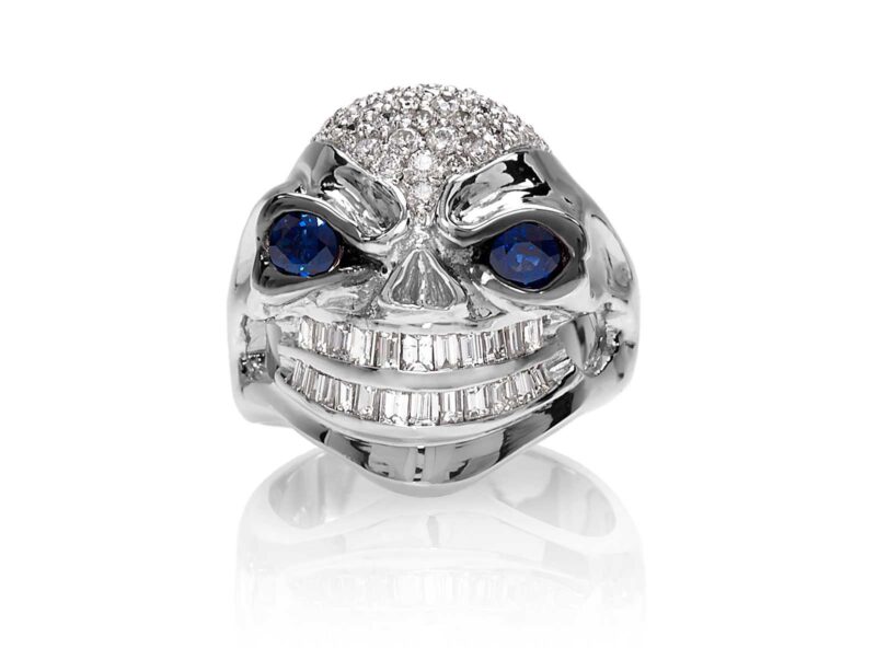 RG3026WG-A Vicious Vinnie Skull Ring (Front View) in White Gold with White Diamonds and Blue Sapphires, designed by Steve Soffa