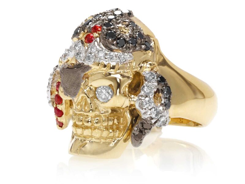 RG1042 Captain Morgan Men's Pirate Skull Ring (Front Left View) in Yellow Gold with White and Black Diamonds, with Orange Sapphires, designed by Steve Soffa