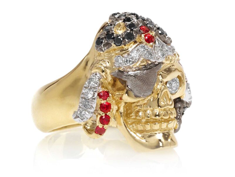 RG1042 Captain Morgan Men's Pirate Skull Ring (Front Right View) in Yellow Gold with White and Black Diamonds, with Orange Sapphires, designed by Steve Soffa