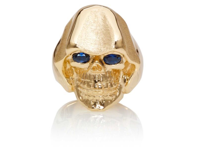 RG5010-B The Reaper Is In Skull Ring (Front View), Yellow with Rose Gold, with Blue Sapphires, designed by Steve Soffa